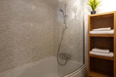 a bathroom with a shower and a bath tub at Neige Apartment - Chamonix All Year in Chamonix-Mont-Blanc