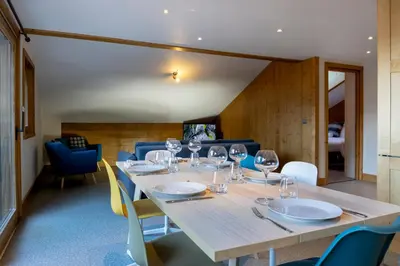 a dining room with a table with wine glasses at La Snaille des Planards in Chamonix-Mont-Blanc