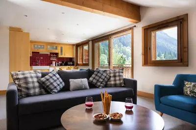a living room with a couch and a table at La Snaille des Planards in Chamonix-Mont-Blanc