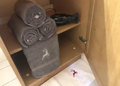 a wooden cabinet with towels and a phone on it at Studio Argentière Chamonix Mont-Blanc in Chamonix-Mont-Blanc