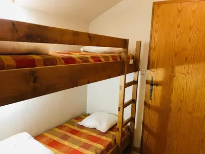 two bunk beds in a room with a ladder at Studio avec balcon et animaux admis - FR-1-629-92 in Samoëns
