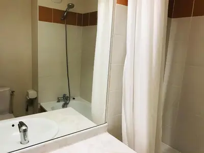 a bathroom with a sink and a shower curtain at Studio avec balcon et animaux admis - FR-1-629-92 in Samoëns