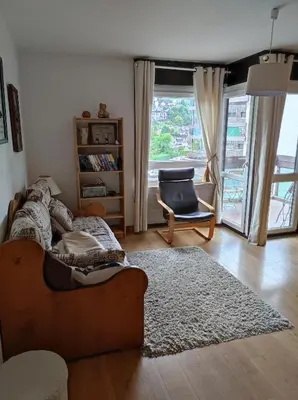 a living room with a couch and a chair at Appartement proche village et remontées mécaniques in Saint-Gervais-les-Bains