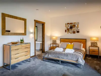 a bedroom with a bed and a dresser and a mirror at Chalet Woodman - OVO Network in Saint-Gervais-les-Bains