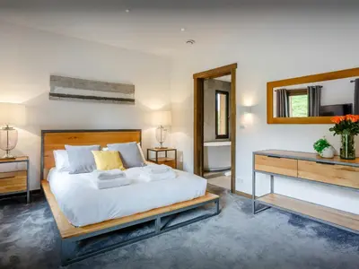 a bedroom with a bed and a desk and a mirror at Chalet Woodman - OVO Network in Saint-Gervais-les-Bains