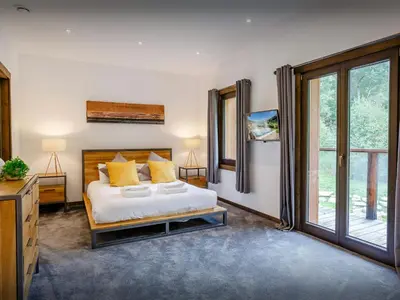 a bedroom with a bed and a large window at Chalet Woodman - OVO Network in Saint-Gervais-les-Bains