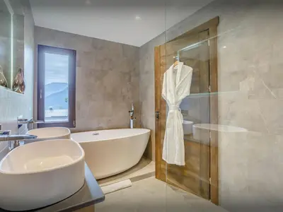 a bathroom with a tub and a sink and a shower at Chalet Woodman - OVO Network in Saint-Gervais-les-Bains