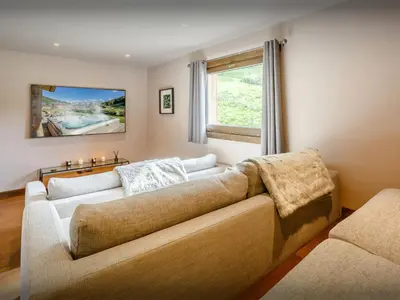 a living room with a couch and a window at Chalet Woodman - OVO Network in Saint-Gervais-les-Bains
