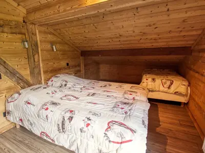 a bedroom with a bed in a wooden cabin at Chalet au pied des pistes, sauna et terrasse, pour 12 pers. - FR-1-642-5 in Morillon