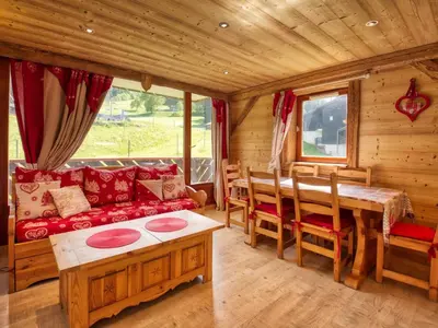a log cabin living room with a red couch and a table at Appartement en montagne, 6 pers., balcon sud - FR-1-642-18 in Morillon
