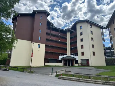 a table and chairs on a balcony with a field at Appartement en montagne, 6 pers., balcon sud - FR-1-642-18 in Morillon