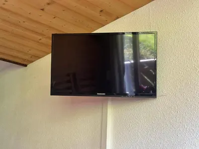 a flat screen tv hanging on a wall at Appartement en montagne, 6 pers., balcon sud - FR-1-642-18 in Morillon