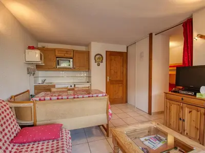a living room with a bed and a tv at Appartement confortable pour 6 pers. avec balcon à Morillon - FR-1-642-11 in Morillon