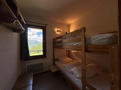 a bedroom with two bunk beds and a window at Appartement confortable 6 pers, proche jardin d'enfants - FR-1-642-15 in Morillon