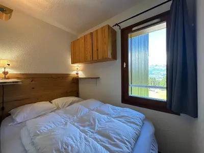 a bedroom with a white bed in a room at Appartement confortable 6 pers, proche jardin d'enfants - FR-1-642-15 in Morillon