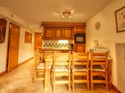 a kitchen with a wooden table and chairs at Appartement 2 ch - 6 pers - Pieds des pistes à Morillon - FR-1-642-21 in Morillon