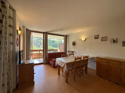 a living room with a table and chairs and a window at Appartement chaleureux 6 personnes proche pistes de ski - FR-1-642-27 in Morillon