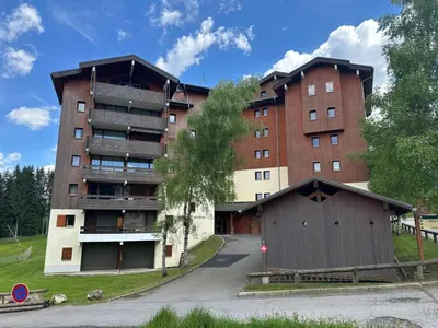 a kitchen with a white refrigerator and wooden cabinets at Appartement chaleureux 6 personnes proche pistes de ski - FR-1-642-27 in Morillon