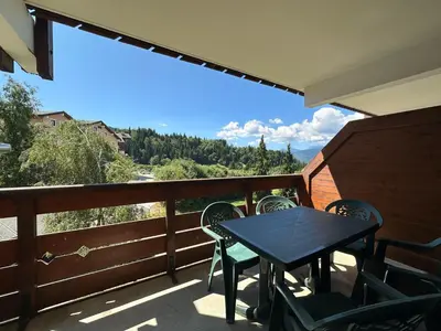 a park with a bench on a hill with trees at Appartement chaleureux 6 personnes proche pistes de ski - FR-1-642-27 in Morillon