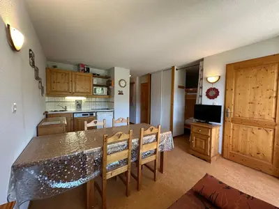 a kitchen with a table and chairs and a dining room at Appartement chaleureux 6 personnes proche pistes de ski - FR-1-642-27 in Morillon