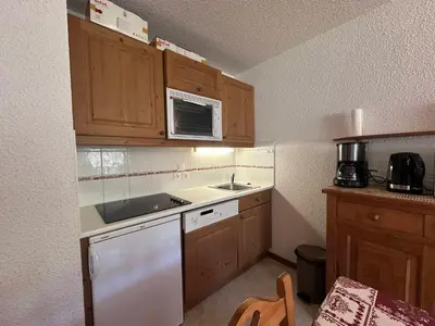 a bedroom with a bed and wooden cabinets at Charmant appartement 6 pers, balcon avec vue montagne, confort moderne, non-fumeur - FR-1-642-32 in Morillon