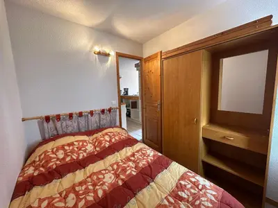 a bedroom with a bed with a dresser and a television at Appartement confortable 6 pers au pied des pistes à Morillon - FR-1-642-37 in Morillon