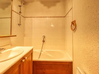 a bathroom with a shower and a tub and a sink at Appartement confortable 6 pers proche jardin enfants - FR-1-642-24 in Morillon