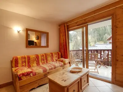 a living room with a couch and a table at Appartement 7 pers, proche des pistes, balcon - FR-1-642-40 in Morillon