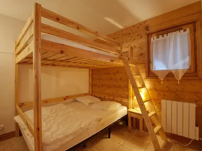 a bunk bed in a wooden room with a ladder at Appartement 7 pers, proche des pistes, balcon - FR-1-642-40 in Morillon