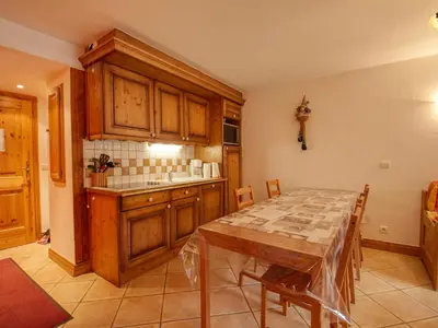 a kitchen with a wooden table and a table and chairs at Appartement 7 pers, proche des pistes, balcon - FR-1-642-40 in Morillon