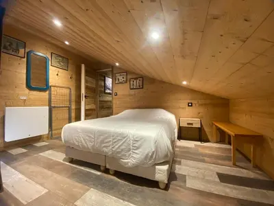 a bedroom with a bed in a wooden room at Appartement duplex rénové 6p, expo sud - FR-1-642-56 in Morillon
