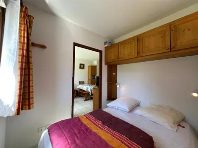 a bedroom with a bed and a large mirror at Appartement cosy 6 pers avec balcon en montagne - FR-1-642-53 in Morillon
