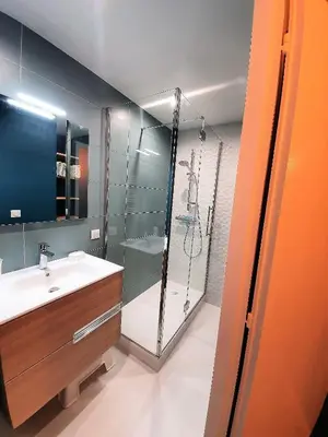 a bathroom with a glass shower and a sink at Chamonix Appartement Vue Mont Blanc avec jardin in Chamonix-Mont-Blanc