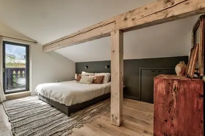 a bedroom with a large bed and a large window at Chalet Alouette in Chamonix-Mont-Blanc