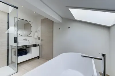 a white bathroom with a sink and a mirror at Chalet Alouette in Chamonix-Mont-Blanc