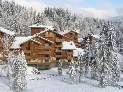 a log cabin building in the snow with trees at Bel appartement 3 ch, déco montagne, au pied des pistes - FR-1-642-57 in Morillon