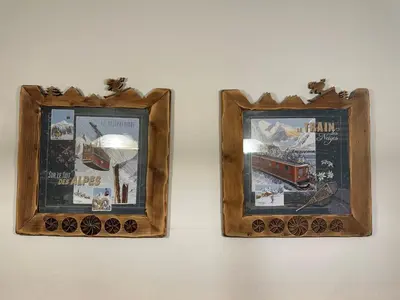 two framed pictures of a train on a wall at Bel appartement 3 ch, déco montagne, au pied des pistes - FR-1-642-57 in Morillon