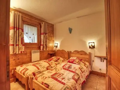 a bedroom with a bed in a room with a window at Bel appartement 3 ch, déco montagne, au pied des pistes - FR-1-642-57 in Morillon