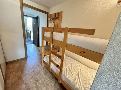 a room with two bunk beds and a mirror at Studio avec alcôve et cabine, 4 couchages à Demi-Quartier, parking inclus - FR-1-597-115 in Demi-Quartier