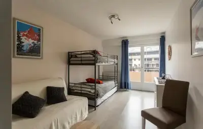 a living room with a couch and a bunk bed at DRYADES SAINT GERVAIS in Saint-Gervais-les-Bains
