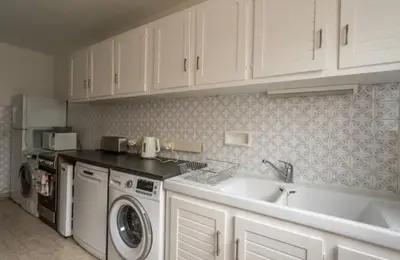 a kitchen with a sink and a washing machine at DRYADES SAINT GERVAIS in Saint-Gervais-les-Bains
