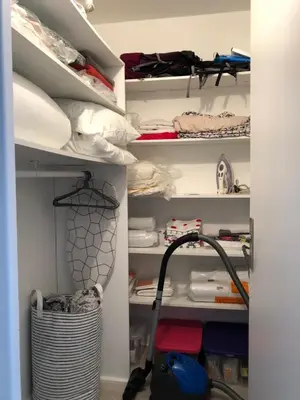 a walk in closet with white shelves and a vacuum at DRYADES SAINT GERVAIS in Saint-Gervais-les-Bains