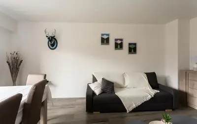 a bedroom with a couch and a motorcycle on the wall at DRYADES SAINT GERVAIS in Saint-Gervais-les-Bains