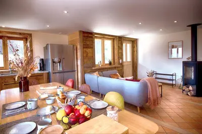 a living room with a couch and a table at La Ferme des Fingères in Cordon