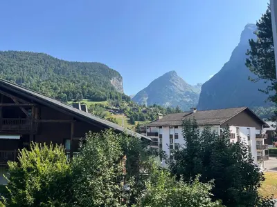 a view of a town with mountains in the background at Studio chaleureux avec balcon au centre de Samoëns - FR-1-624-83 in Samoëns