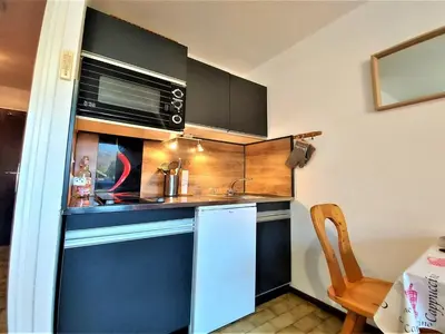 a small kitchen with a sink and a microwave at Studio chaleureux avec balcon au centre de Samoëns - FR-1-624-83 in Samoëns