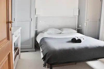 a bedroom with a bed with two shoes on it at Les Grand Balcon - 2ch - 2 balcons - Randonnée - Escalade - Lac des Chavants in Les Houches