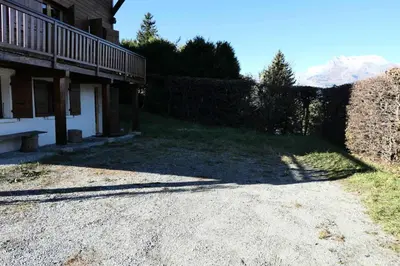 a dirt road next to a house with a fence at Chalet Le Bionnassay - Chalet le Bionnassay MAE-8134 in Saint-Gervais-les-Bains