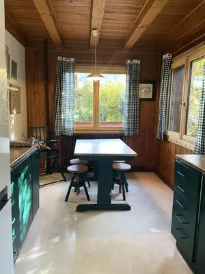a kitchen with a table and two stools in it at Chalet Le Bionnassay - Chalet le Bionnassay MAE-8134 in Saint-Gervais-les-Bains