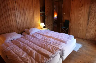 a bedroom with a large bed in a wooden room at Chalet Le Bionnassay - Chalet le Bionnassay MAE-8134 in Saint-Gervais-les-Bains